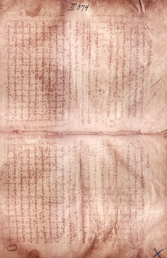 An unfolded parchment page in brown tones, with faint older writing running one way underneath darker medieval prayer text running the other way.
