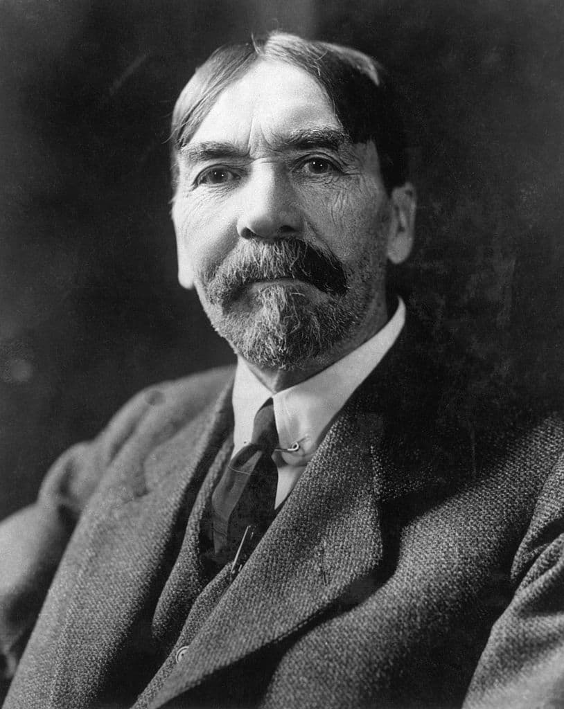 Black-and-white portrait of Thorstein Veblen, a man with a moustache and short beard wearing a suit