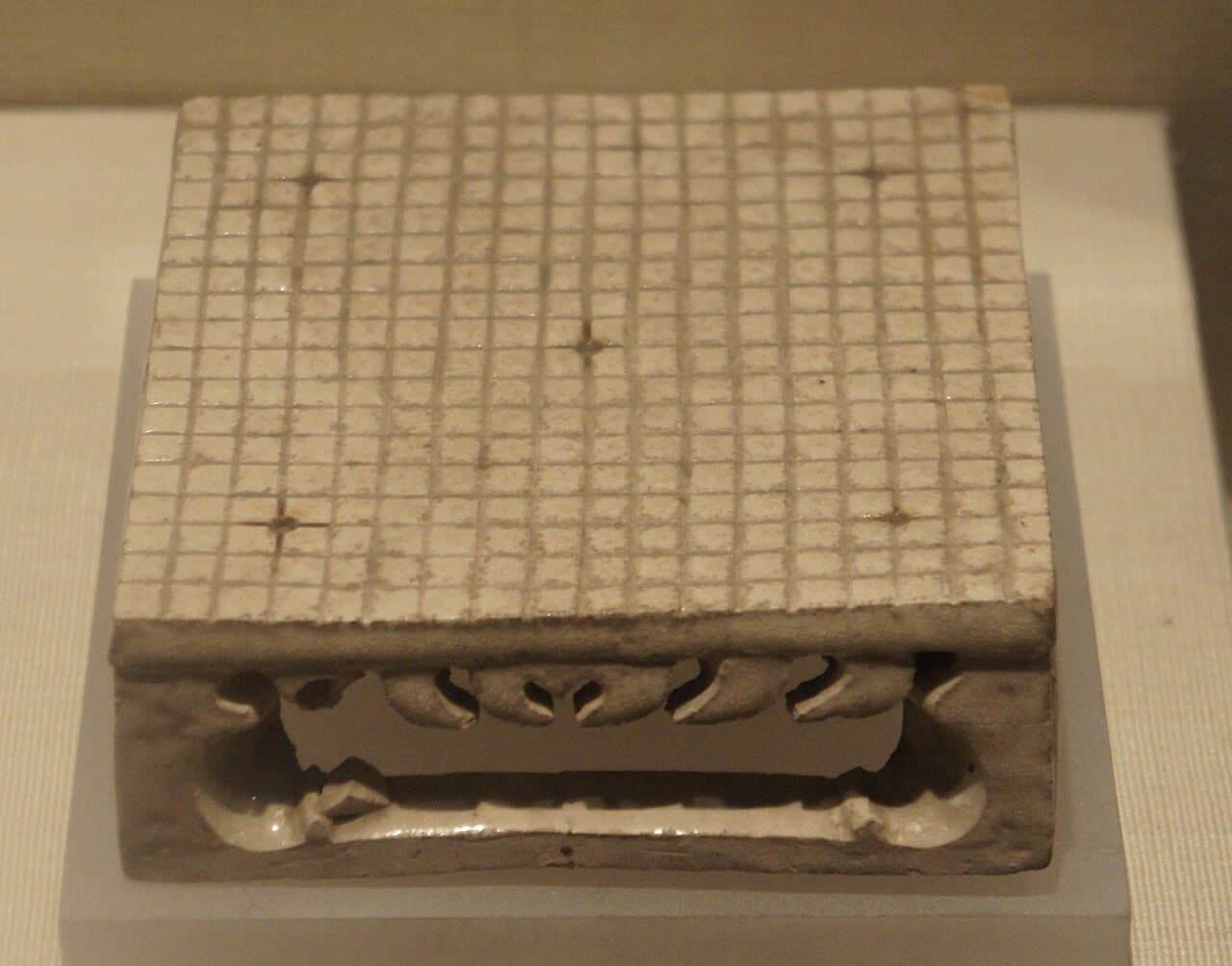 A small square model of a Go board with a 19×19 grid of lines, excavated from a Chinese tomb.
