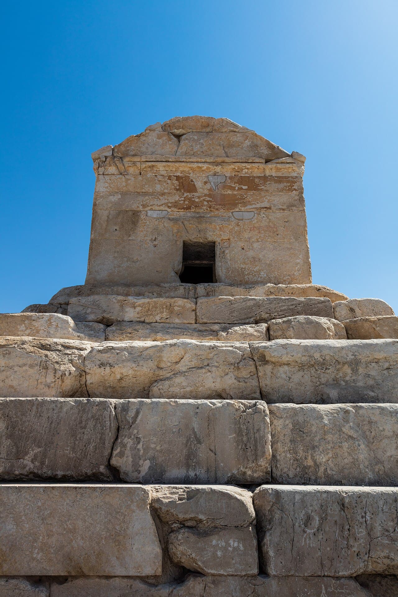 The stone tomb of Cyrus the Great at Pasargadae, Iran, a small rectangular structure on a stepped base.