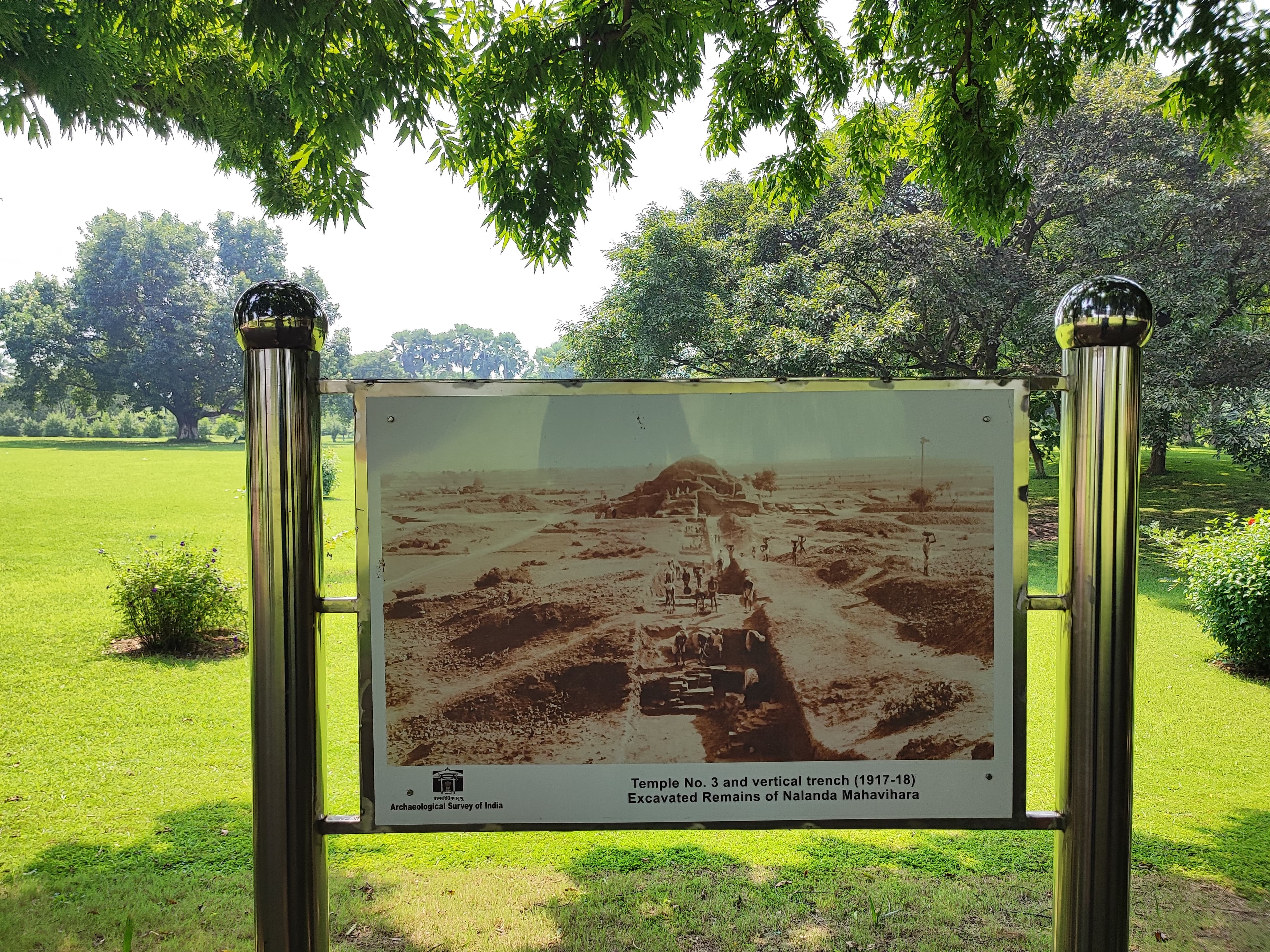 Brick ruins of the ancient Nalanda monastic university in India, with rows of low walls and stupa foundations.