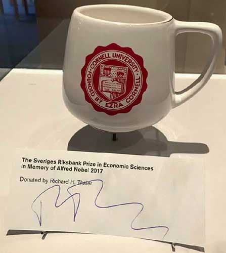A plain Cornell University coffee mug on display.
