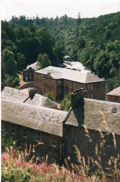 The New Lanark mill buildings beside the River Clyde in Scotland.