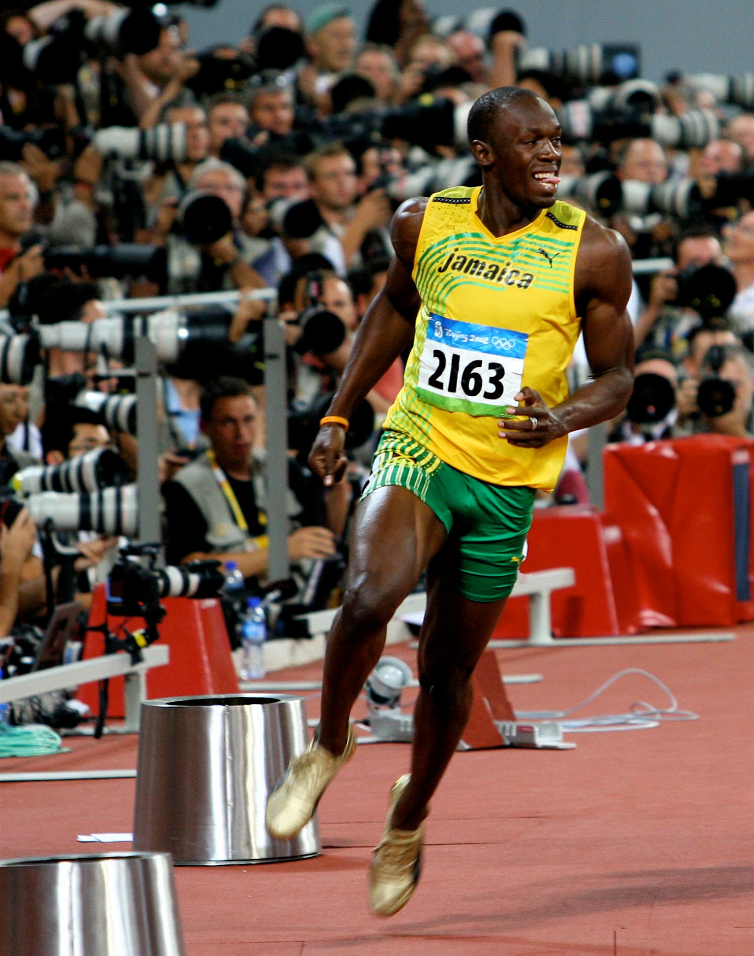 Usain Bolt celebrating with his arms spread during a race.