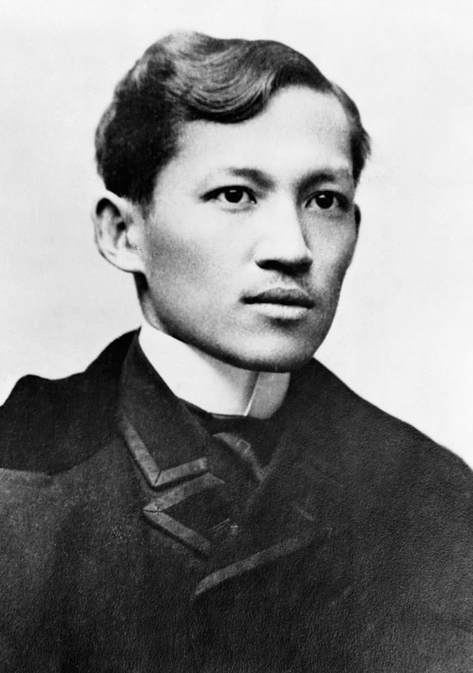 Formal portrait photograph of José Rizal, seated, wearing a dark suit.