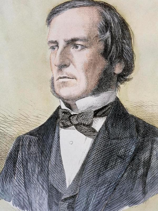 A 19th-century portrait of George Boole, a man with dark hair and sideburns in formal Victorian dress.