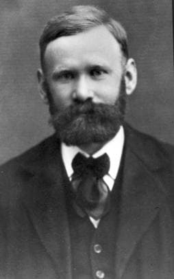 Old portrait photograph of Agner Krarup Erlang, a bearded man in a dark suit and bow tie.