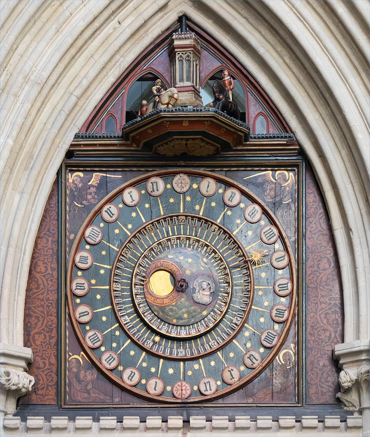 The ornate painted astronomical dial of the medieval clock in Wells Cathedral, England